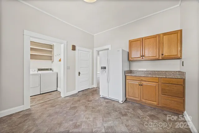 a kitchen with granite countertop cabinets and refrigerator