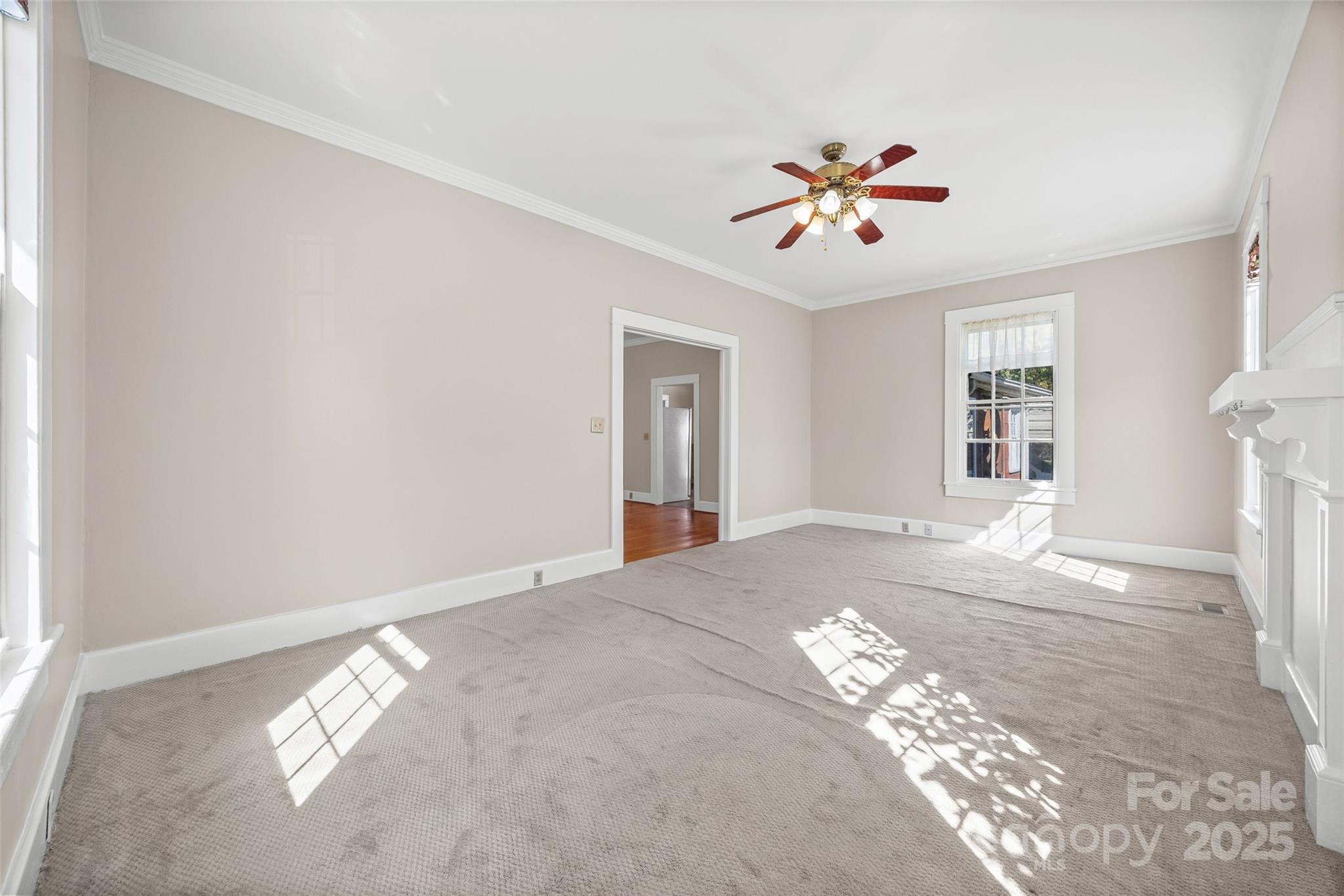 105 Foote Street Chester, SC 29706 - Photo 16 of 28 a view of an empty room with window and chandelier fan