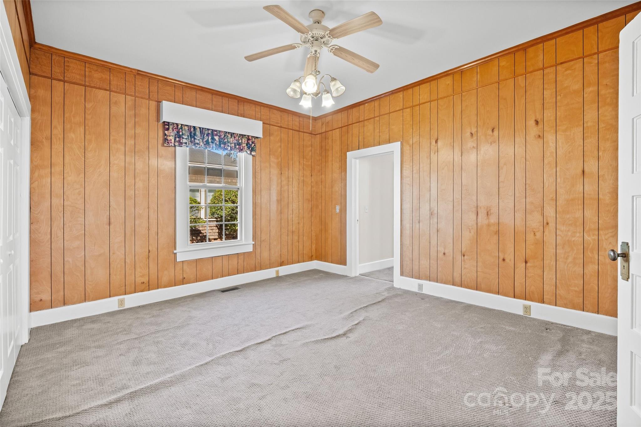 105 Foote Street Chester, SC 29706 - Photo 21 of 28 an empty room with windows and chandelier fan