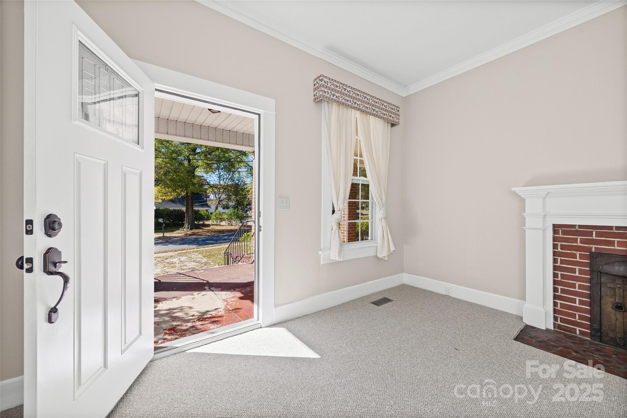 105 Foote Street Chester, SC 29706 - Photo 4 of 28 a view of an empty room with a fireplace and a window