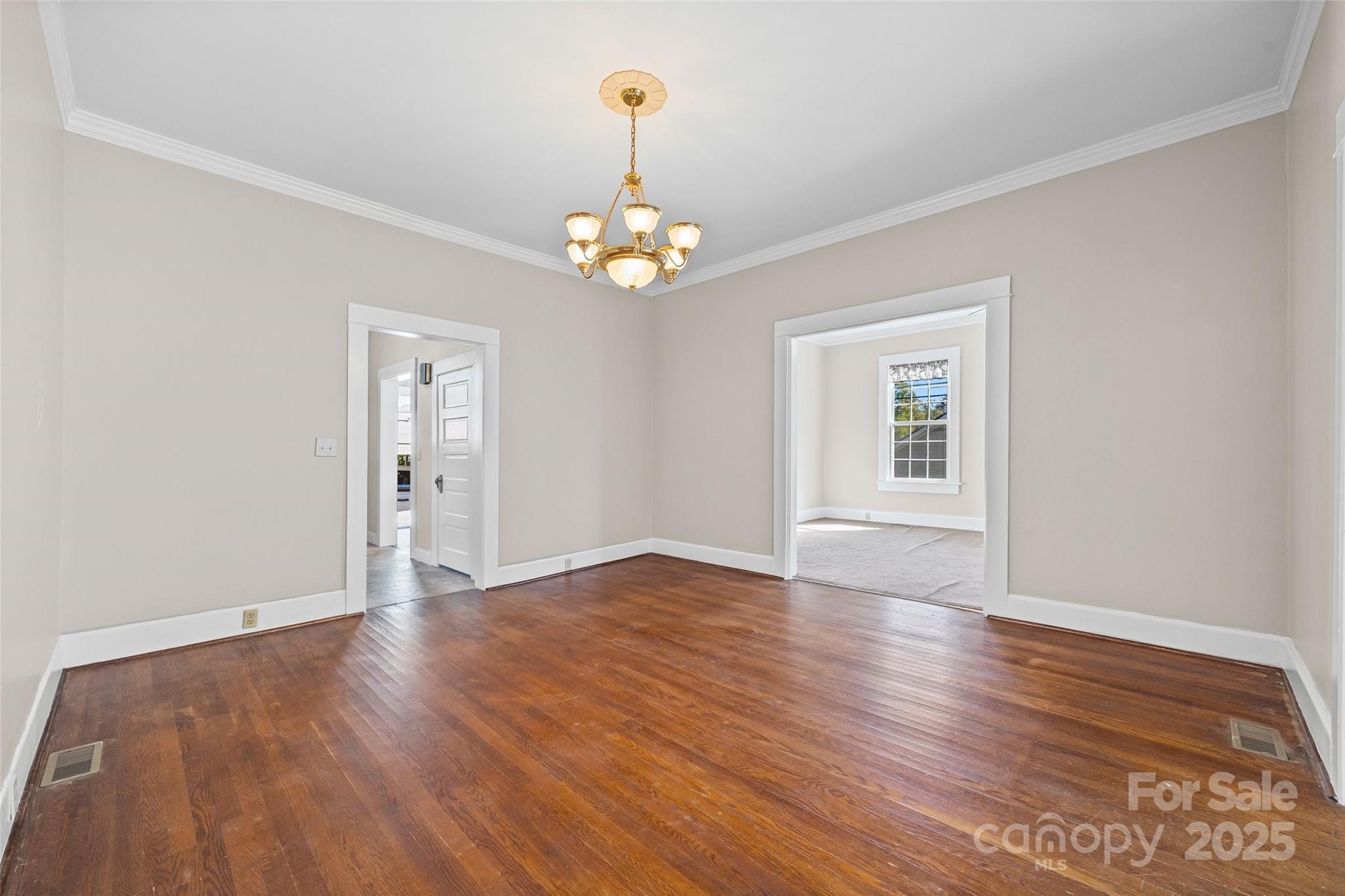 105 Foote Street Chester, SC 29706 - Photo 8 of 28 a view of an empty room with wooden floor and a window