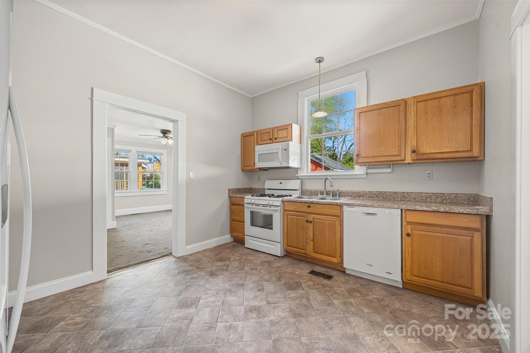 105 Foote Street Chester, SC 29706 - Photo 10 of 28 a kitchen with granite countertop a sink stainless steel appliances and cabinets