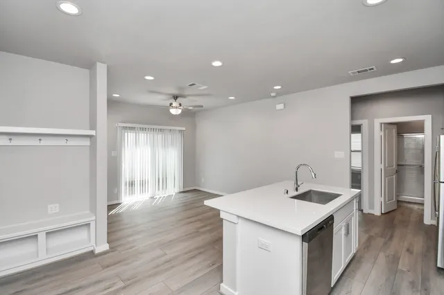 a view living room with stainless steel appliances granite countertop refrigerator sink and cabinets