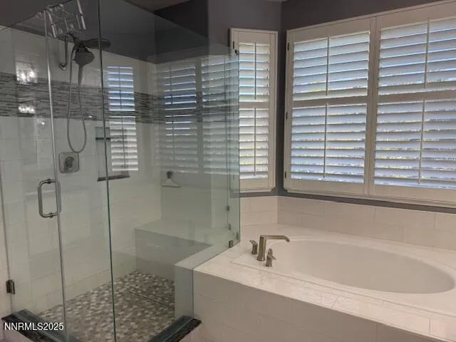 a bathroom with a bathtub and shower