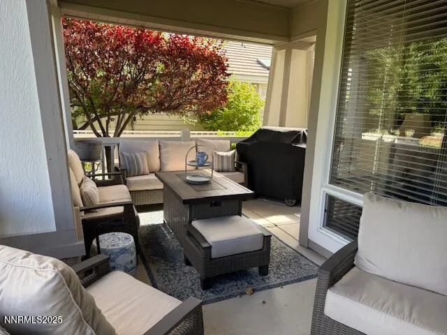 a living room with furniture and a floor to ceiling window