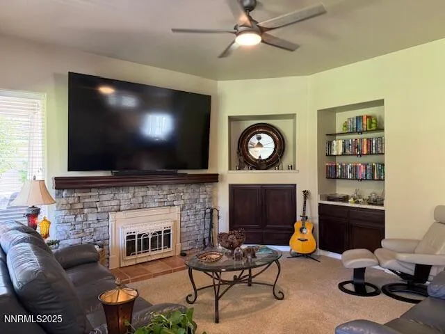 a living room with furniture a flat screen tv and a fireplace