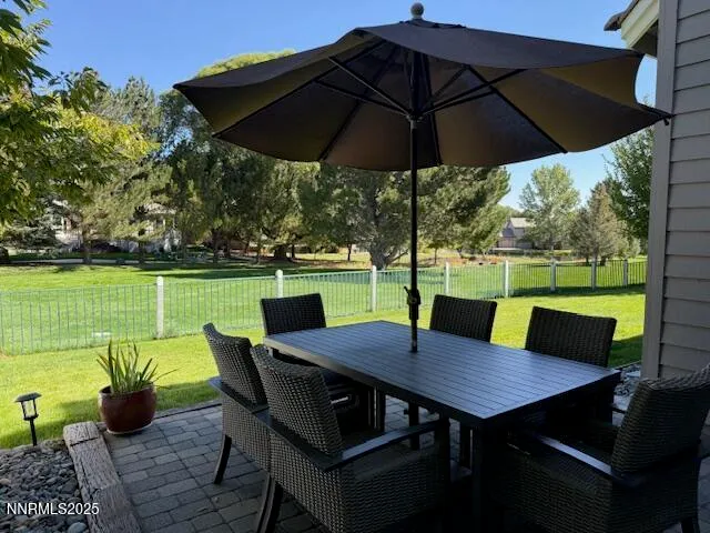 a view of deck with furniture and umbrella