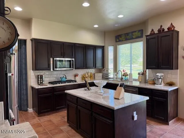 a kitchen with a stove sink and cabinets