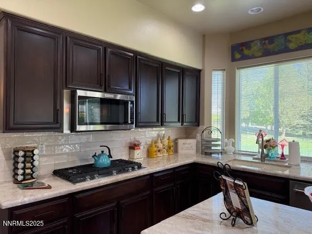 a kitchen with a sink appliances and cabinets