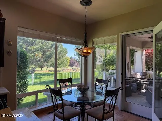 a dining room with furniture window and outside view