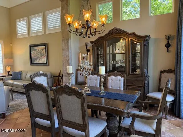 a view of a dining room with furniture and chandelier