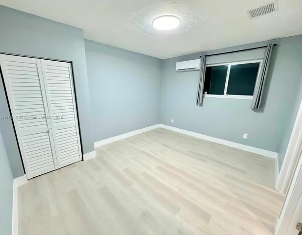 a view of an empty room with windows