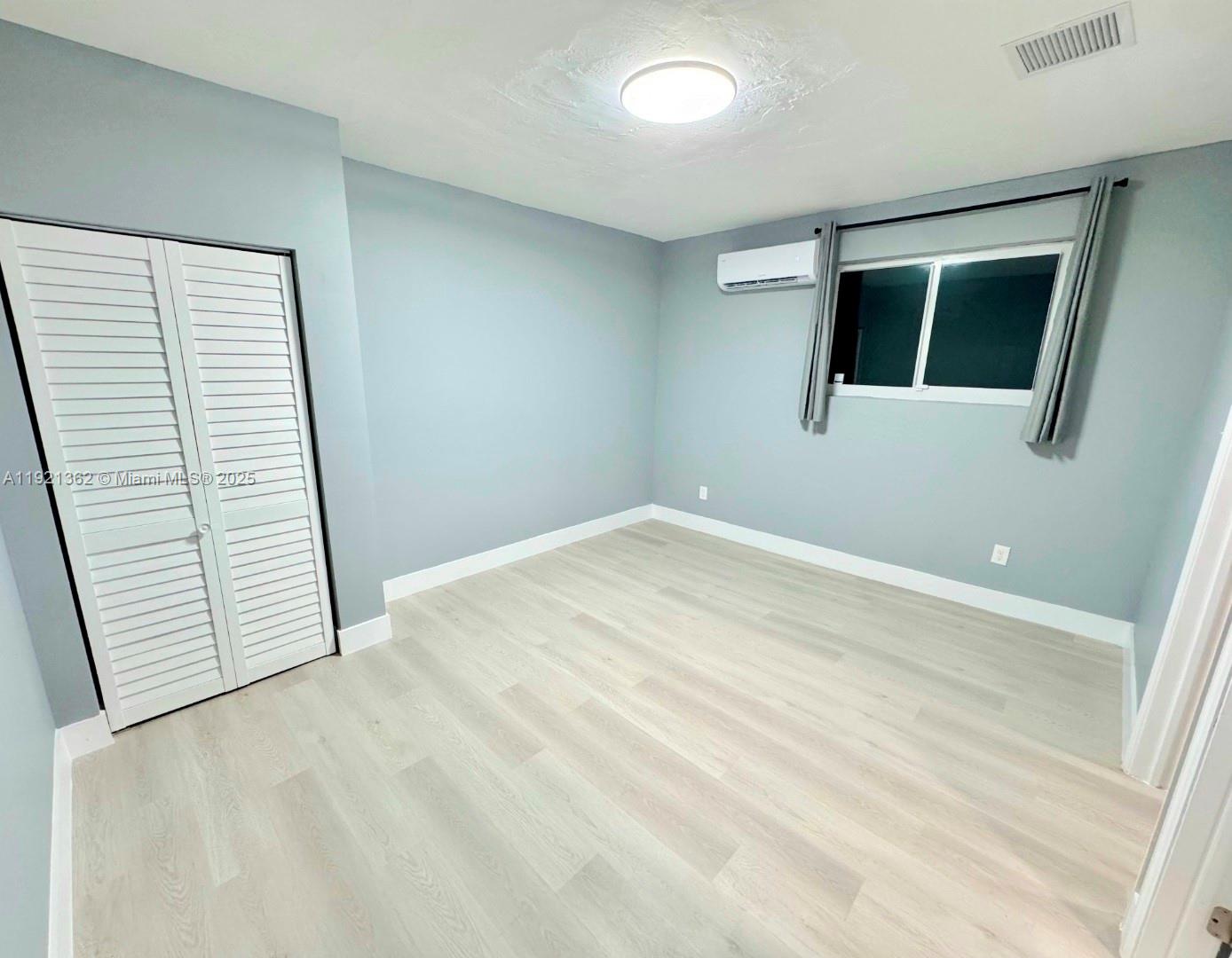 a view of an empty room with windows