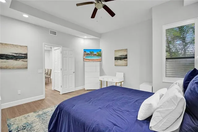 a bedroom with a large bed and a chandelier