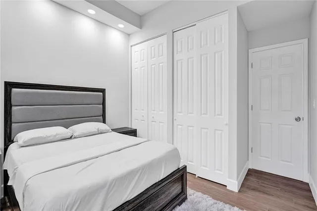 a bedroom with a bed and painting on the wall