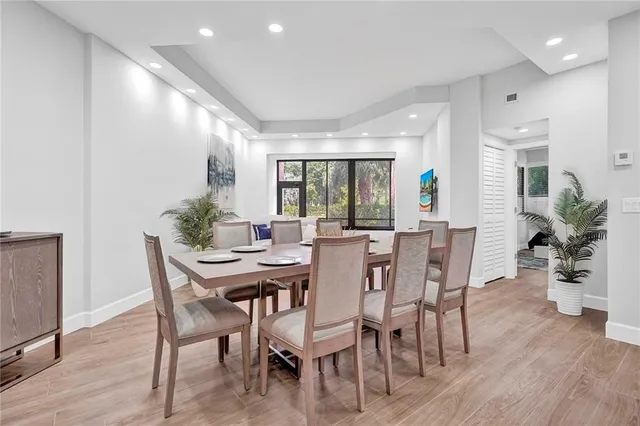a view of a dining room with furniture and wooden floor