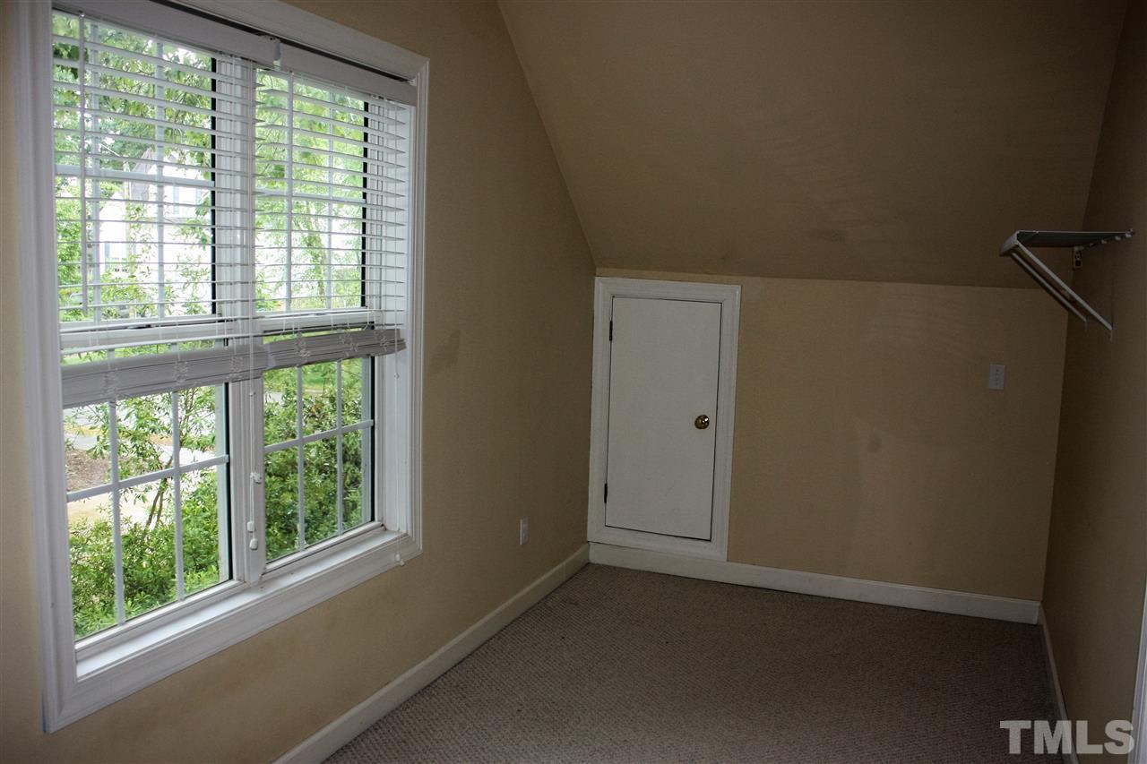 908 Cedar Downs Drive Raleigh, NC 27607 - Photo 12 of 25 a view of an empty room with a window