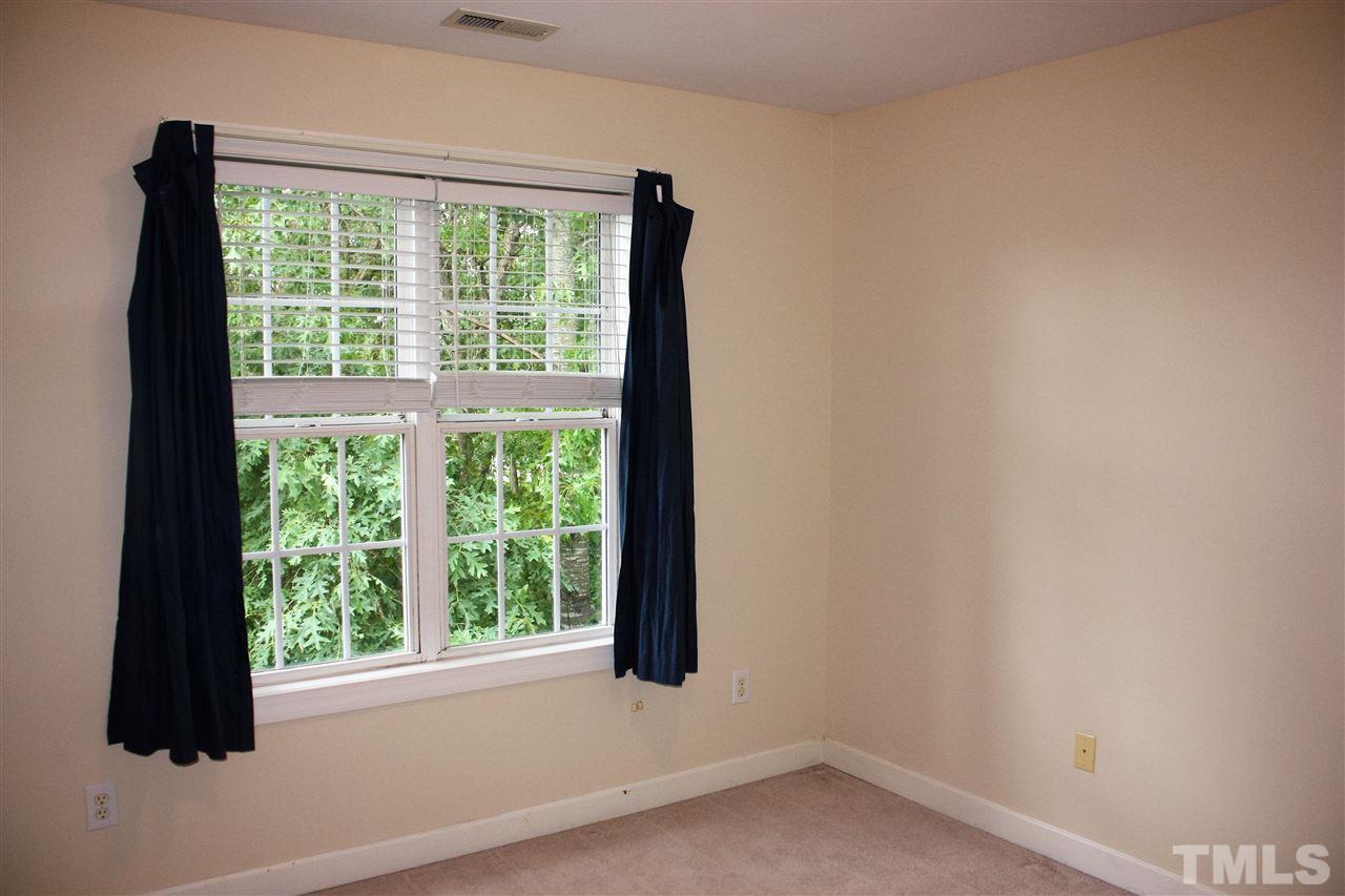908 Cedar Downs Drive Raleigh, NC 27607 - Photo 15 of 25 a view of empty room with windows and backyard