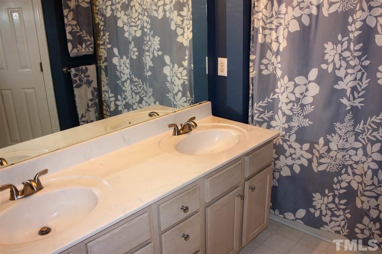 908 Cedar Downs Drive Raleigh, NC 27607 - Photo 19 of 25 a bathroom with a sink and a mirror