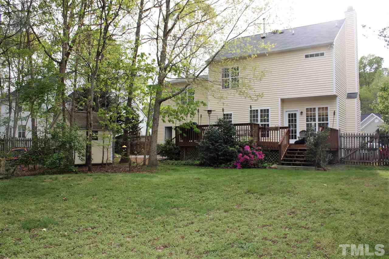 908 Cedar Downs Drive Raleigh, NC 27607 - Photo 25 of 25 a view of a house with a big yard and large trees