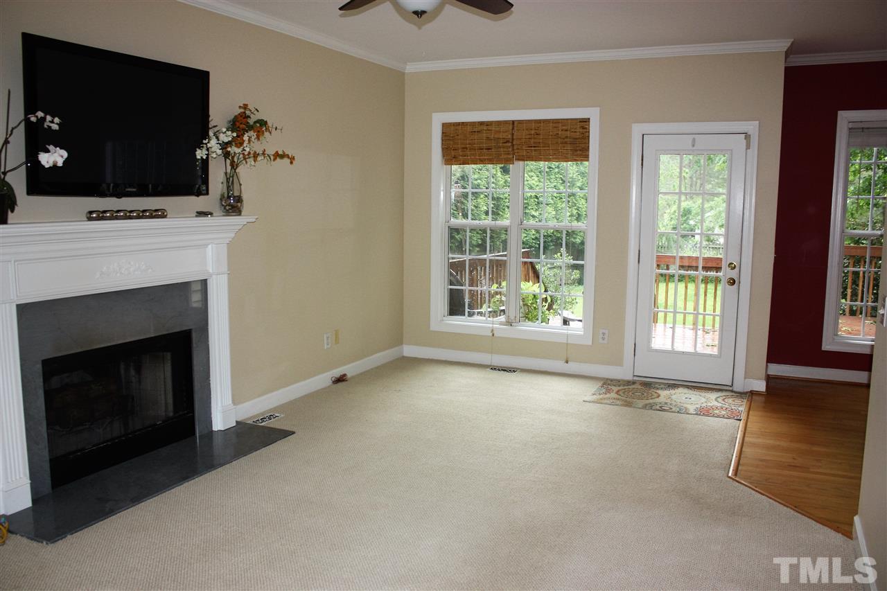 908 Cedar Downs Drive Raleigh, NC 27607 - Photo 4 of 25 a view of an empty room with furniture and a fireplace