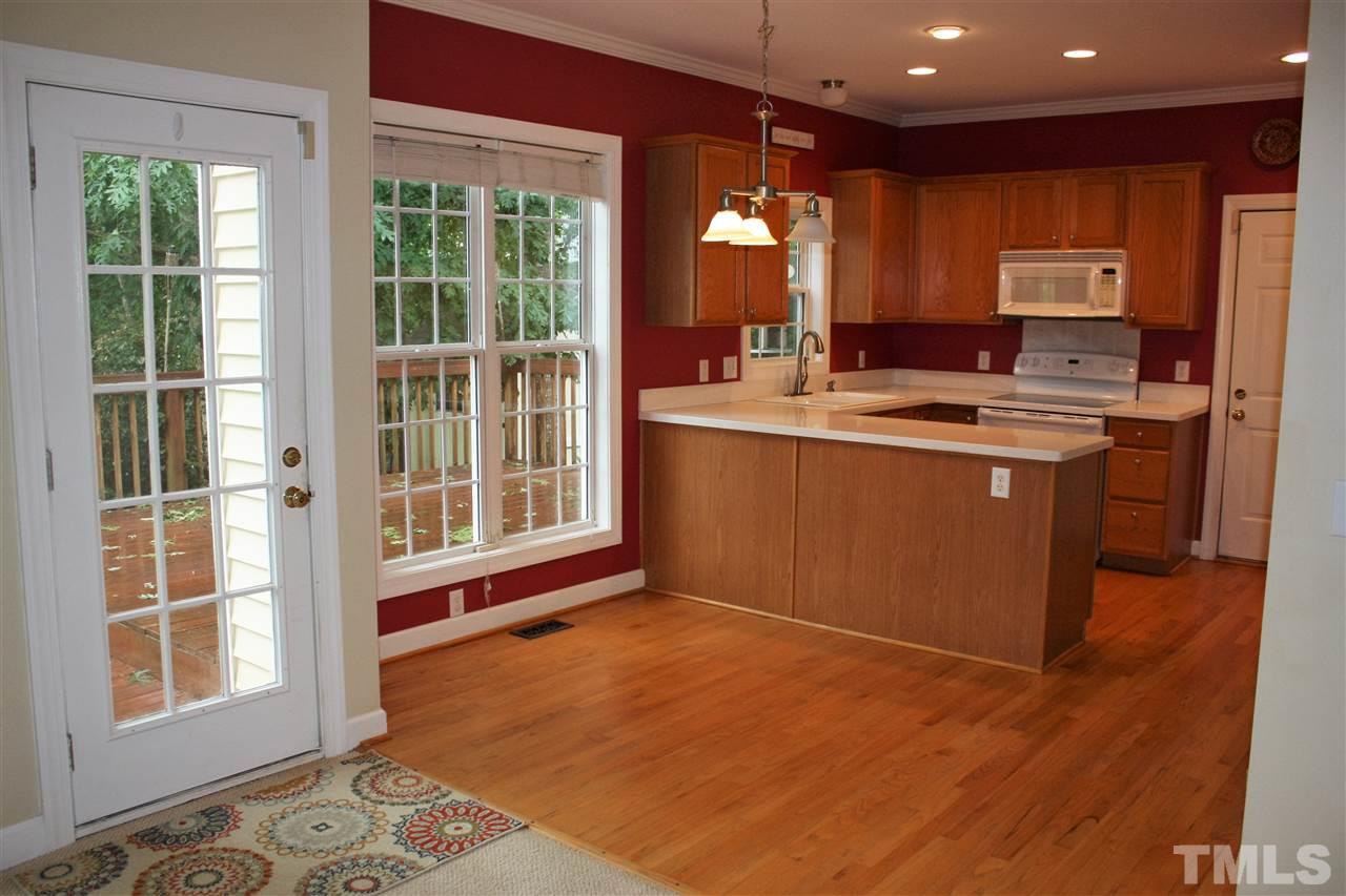 908 Cedar Downs Drive Raleigh, NC 27607 - Photo 7 of 25 a view of kitchen with windows and refrigerator