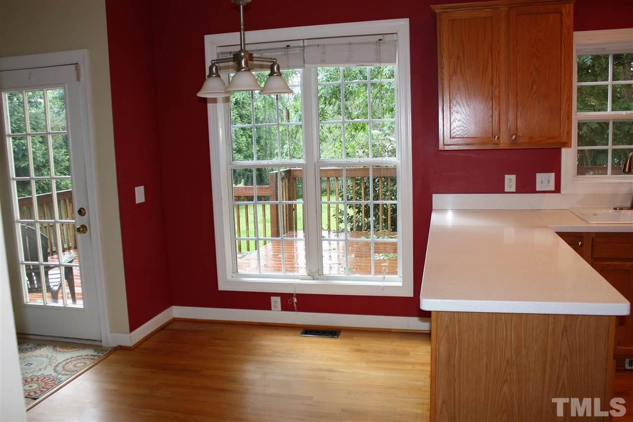 908 Cedar Downs Drive Raleigh, NC 27607 - Photo 8 of 25 a view of a kitchen with wooden floor and windows