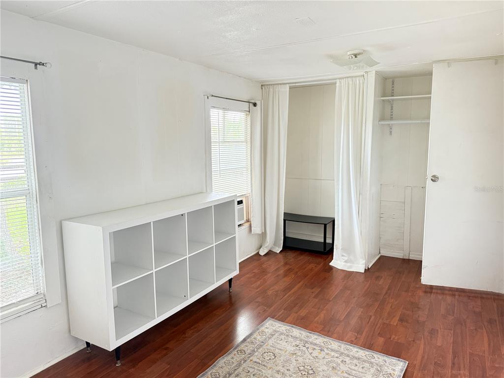 3545 Southwest 90th Street Ocala, FL 34476 - Photo 12 of 24 an empty room with wooden floor cabinet and windows