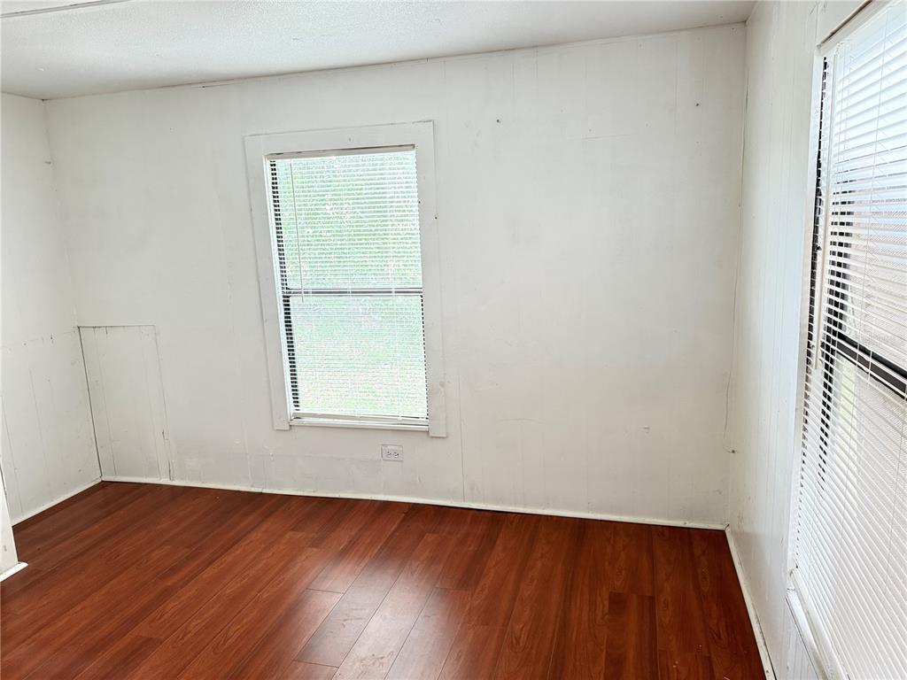 3545 Southwest 90th Street Ocala, FL 34476 - Photo 19 of 24 an empty room with wooden floor and windows