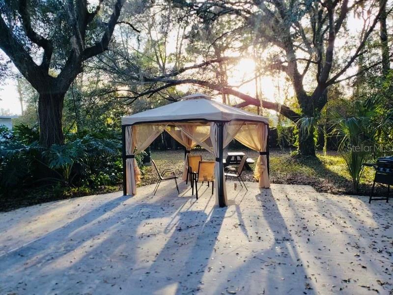 3545 Southwest 90th Street Ocala, FL 34476 - Photo 23 of 24 a view of a wooden bench next to a yard