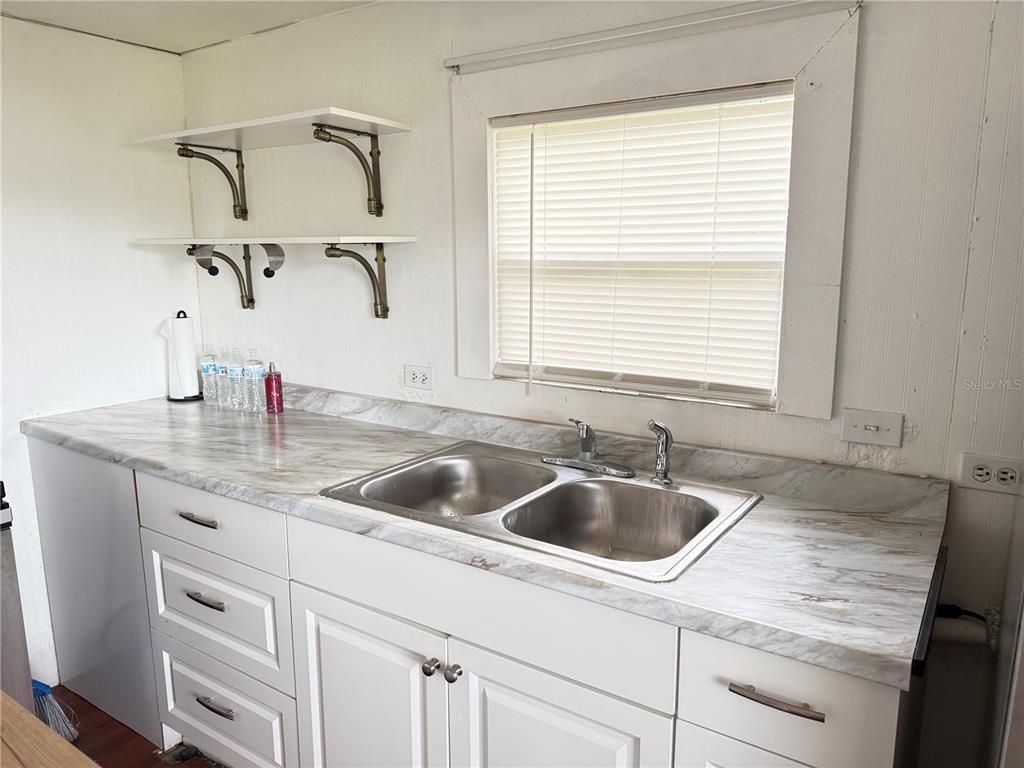 3545 Southwest 90th Street Ocala, FL 34476 - Photo 5 of 24 a kitchen with a sink and cabinets