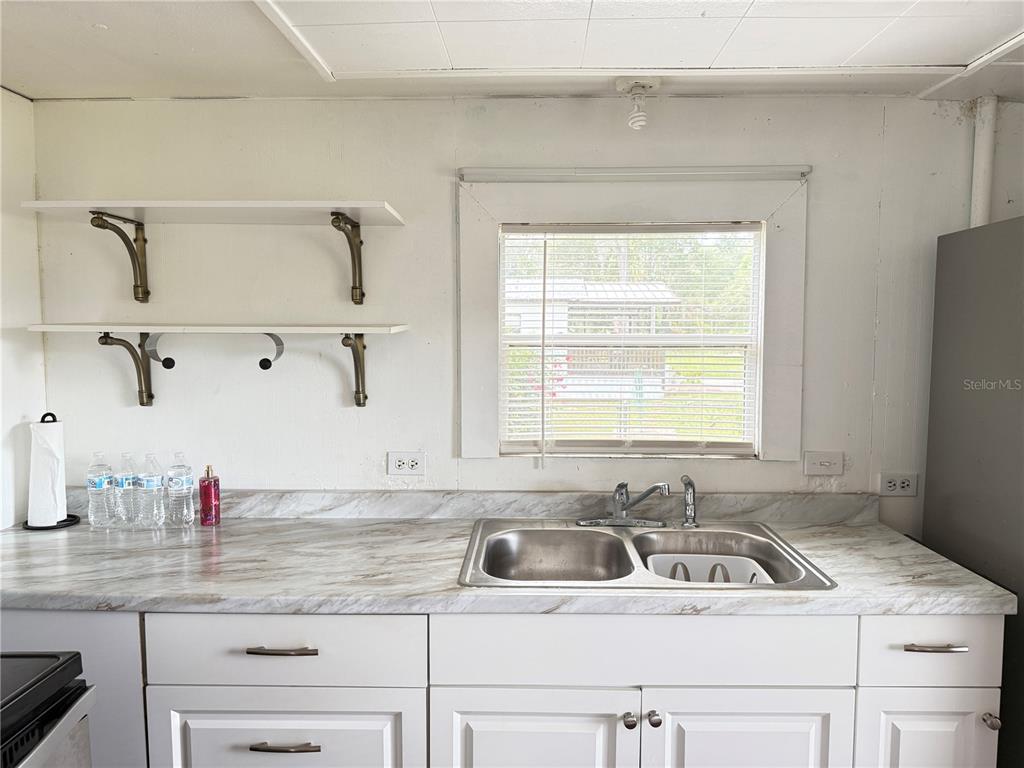 3545 Southwest 90th Street Ocala, FL 34476 - Photo 6 of 24 a kitchen with a sink cabinets and window