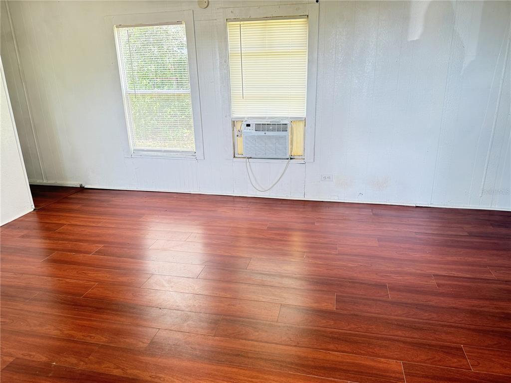 3545 Southwest 90th Street Ocala, FL 34476 - Photo 7 of 24 an empty room with wooden floor and windows