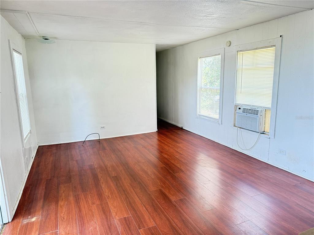 3545 Southwest 90th Street Ocala, FL 34476 - Photo 9 of 24 an empty room with wooden floor and windows