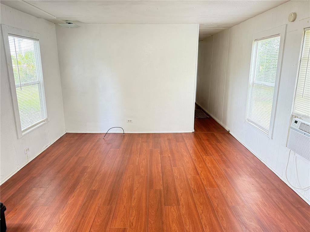 3545 Southwest 90th Street Ocala, FL 34476 - Photo 10 of 24 an empty room with wooden floor and windows
