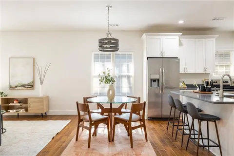 a view of a dining room with furniture wooden floor and a chandelier