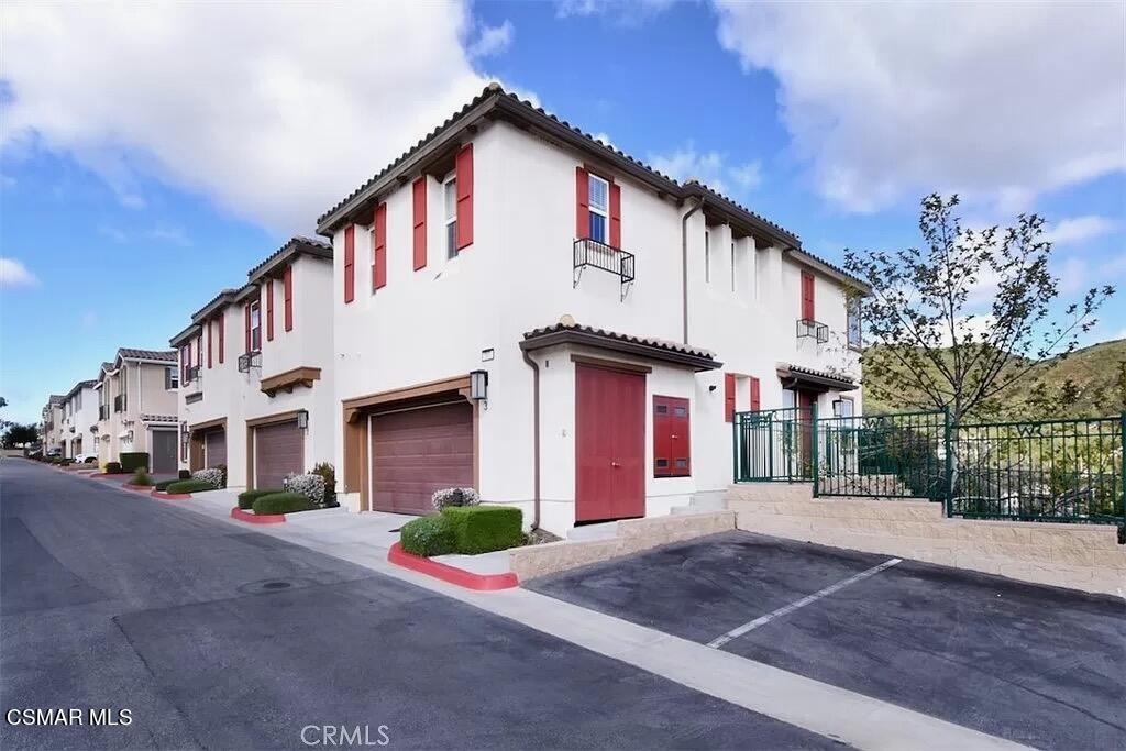 207 Morro Way, Unit 3 Simi Valley, CA 93065 - Photo 1 of 31 a front view of a house with a yard and garage