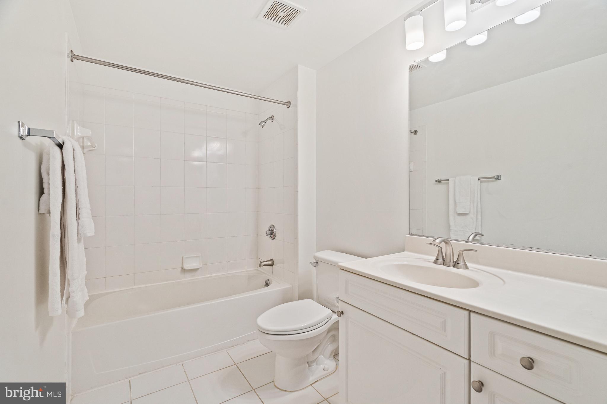 2726 Gallows Road, Unit 712 Vienna, VA 22180 - Photo 20 of 55 a bathroom with a sink a toilet and shower