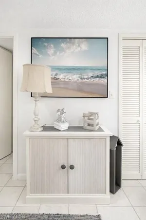 a living room with furniture a mirror and a clock