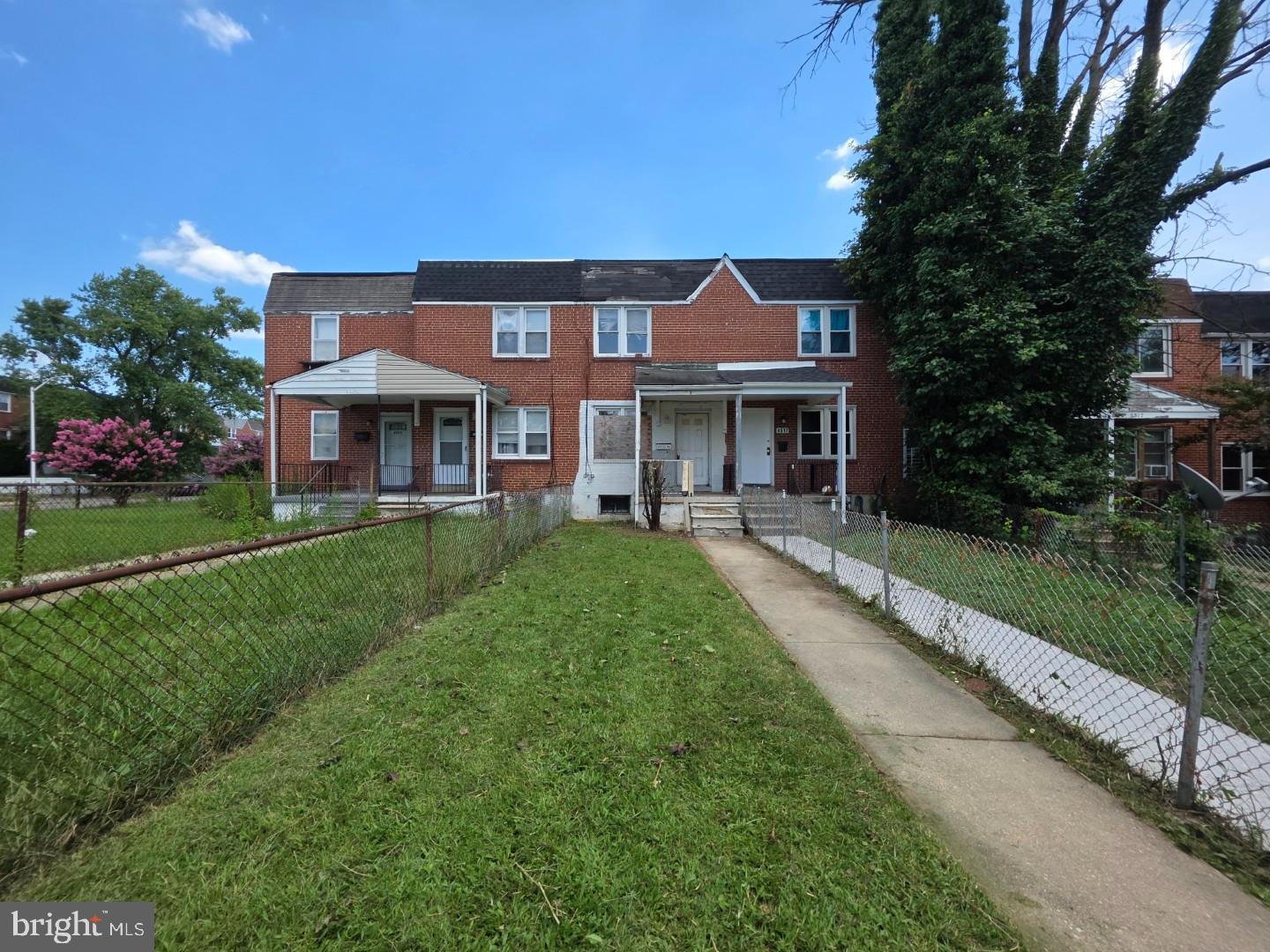 4519 Pall Mall Road Baltimore, MD 21215 - Photo 1 of 19 a front view of a house with a yard table and chairs