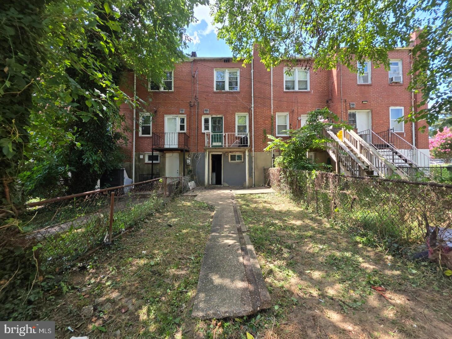 4519 Pall Mall Road Baltimore, MD 21215 - Photo 19 of 19 a view of a yard in front of a brick house with large windows