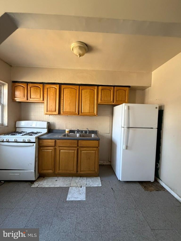 4519 Pall Mall Road Baltimore, MD 21215 - Photo 8 of 19 a kitchen with a refrigerator and a stove