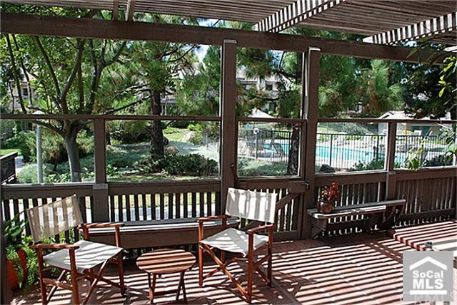 Patio with geenbelt and swimming pool views