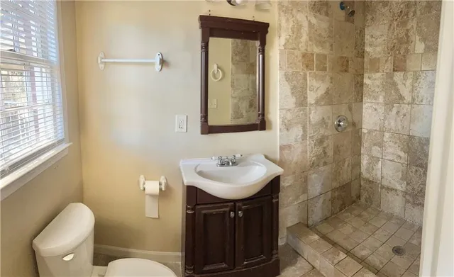 a bathroom with a sink toilet and shower