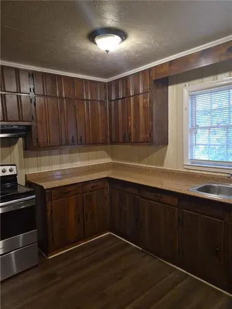 a kitchen with wooden cabinets and a sink