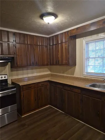 a kitchen with wooden cabinets and a sink