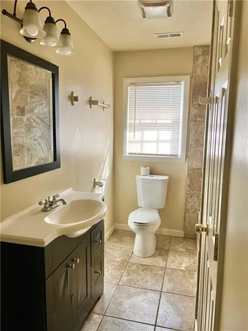 a bathroom with a sink a toilet and mirror