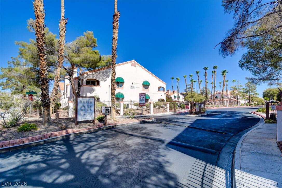 7570 West Flamingo Road, Unit 119 Las Vegas, NV 89147 - Photo 15 of 15 Mature palm trees greet residents entering this charming community with its gated access and appealing architecture.