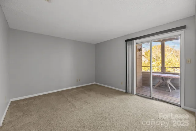 a view of empty room with wooden floor and fireplace