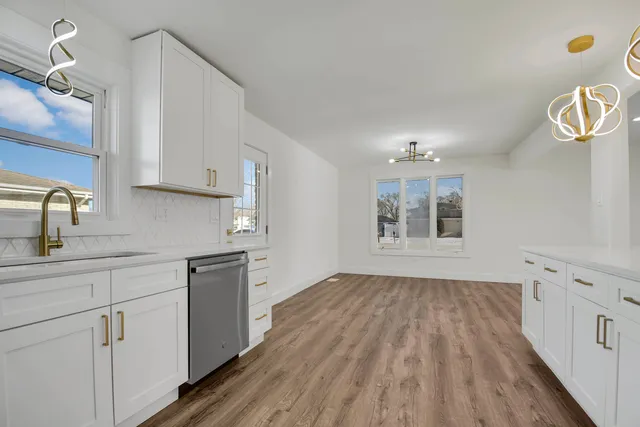 a kitchen with cabinets and wooden floor